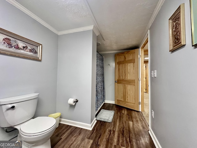 bathroom with hardwood / wood-style flooring, ornamental molding, a textured ceiling, toilet, and walk in shower