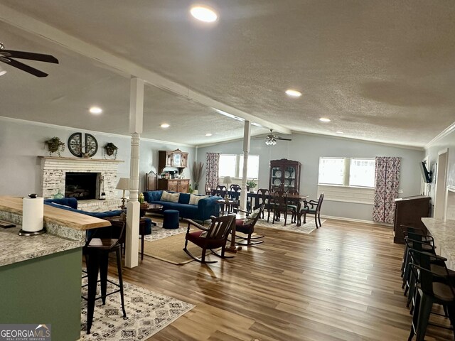 dining space featuring wood-type flooring, vaulted ceiling with beams, and crown molding