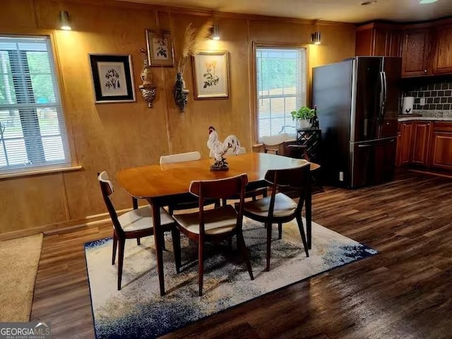 dining space with dark wood-type flooring and plenty of natural light