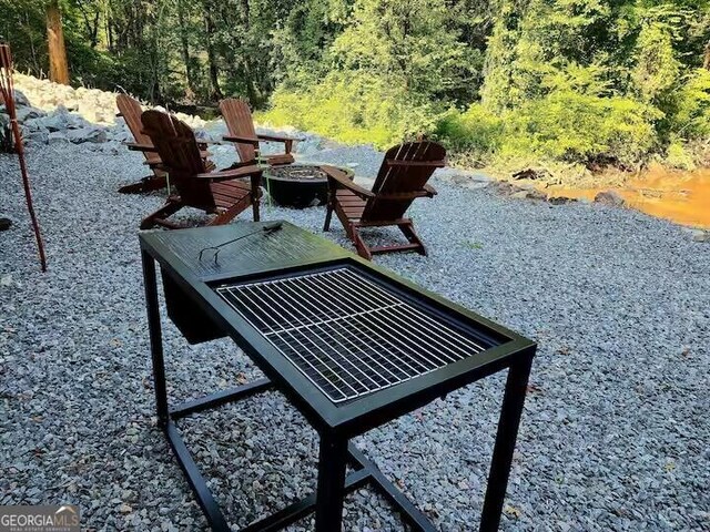 exterior space featuring an outdoor fire pit