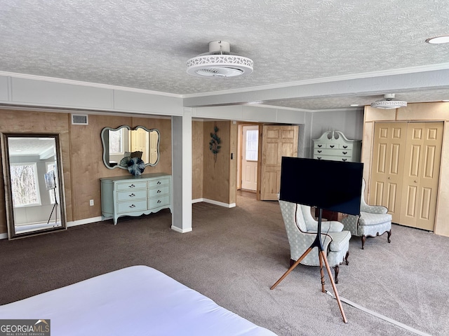 bedroom featuring multiple windows, crown molding, a textured ceiling, and dark colored carpet