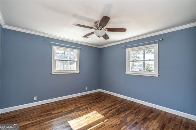 spare room with dark wood-type flooring, ornamental molding, and ceiling fan