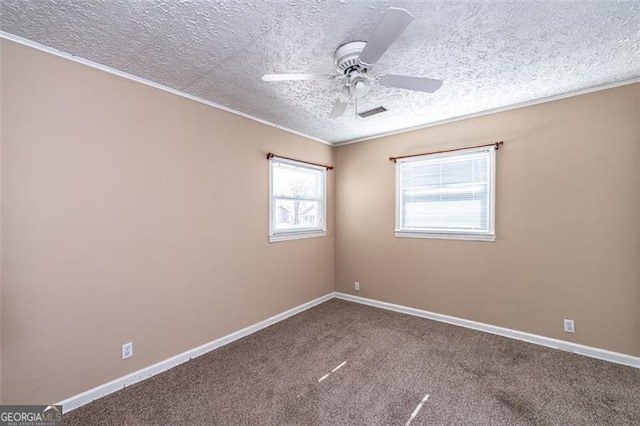 carpeted empty room featuring ceiling fan and a textured ceiling