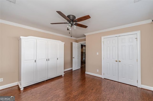 unfurnished bedroom with ornamental molding, ceiling fan, and dark hardwood / wood-style flooring