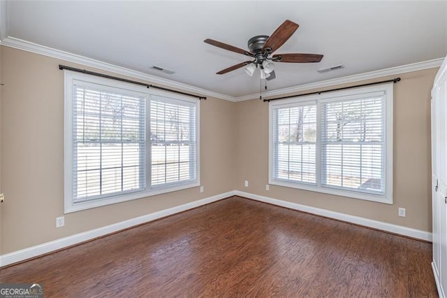 spare room featuring crown molding, ceiling fan, and dark hardwood / wood-style floors