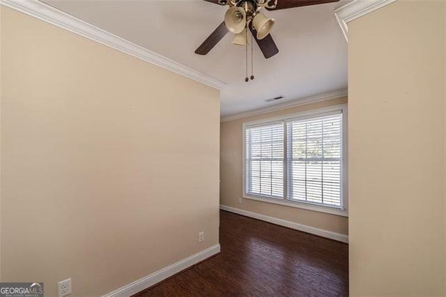 empty room with dark hardwood / wood-style flooring, ornamental molding, and ceiling fan