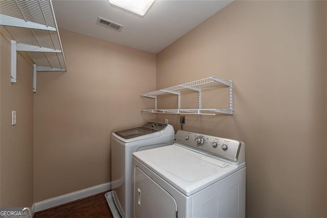 clothes washing area featuring independent washer and dryer