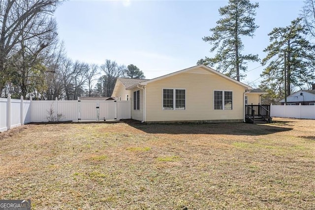 rear view of property with a yard