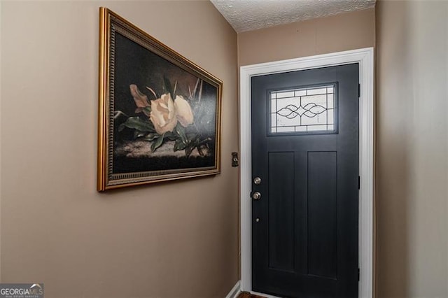 doorway featuring a textured ceiling