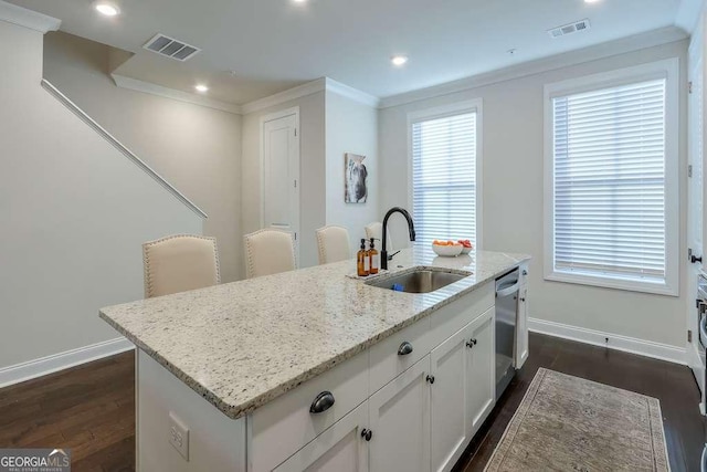 kitchen featuring sink, light stone counters, stainless steel dishwasher, a kitchen island with sink, and white cabinets