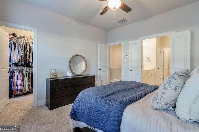 carpeted bedroom featuring ceiling fan, a spacious closet, and a closet