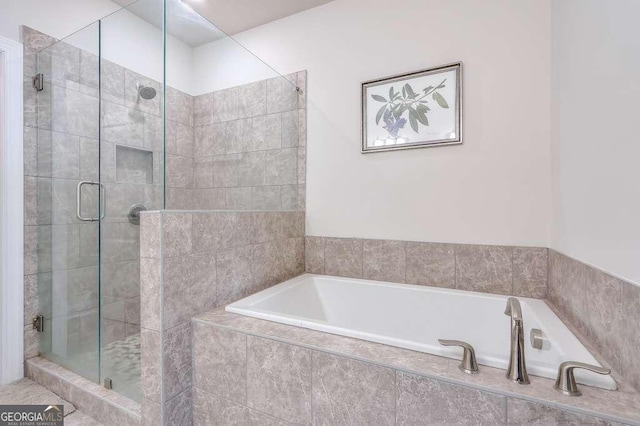 bathroom featuring separate shower and tub