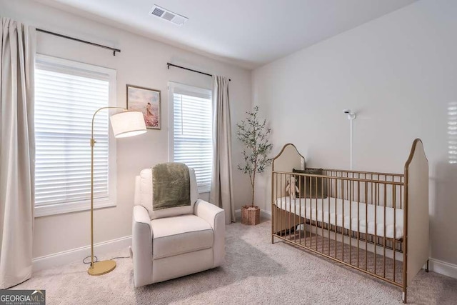 bedroom featuring carpet floors and a crib