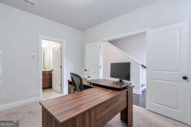 office space with light colored carpet