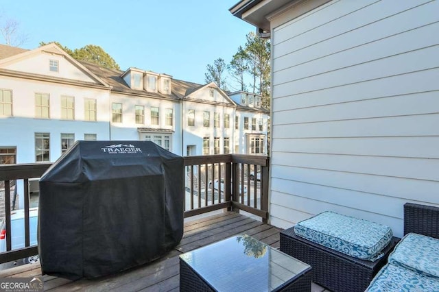 wooden deck with a grill