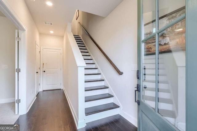 stairway with hardwood / wood-style floors