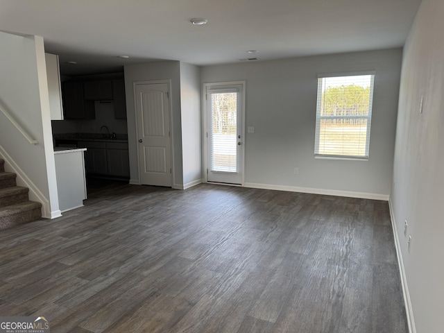 unfurnished living room featuring dark hardwood / wood-style floors