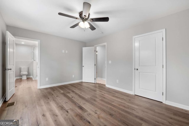 unfurnished bedroom with hardwood / wood-style flooring, ceiling fan, and ensuite bath