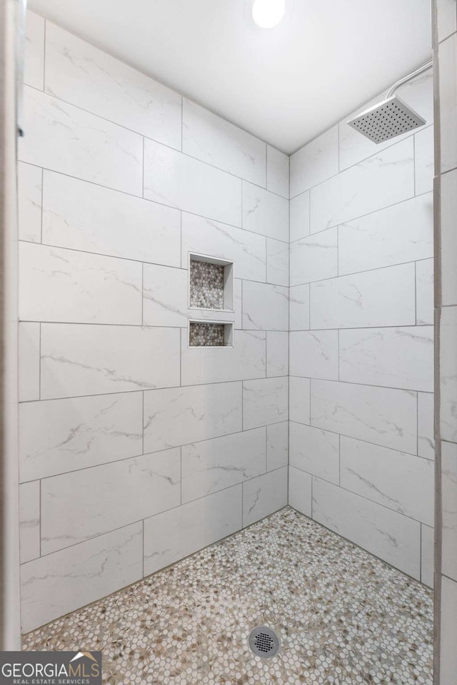 bathroom with tiled shower