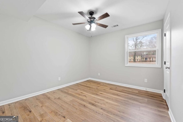 spare room with ceiling fan and light wood-type flooring