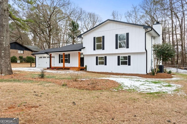 view of front facade featuring a garage, covered porch, and a front lawn