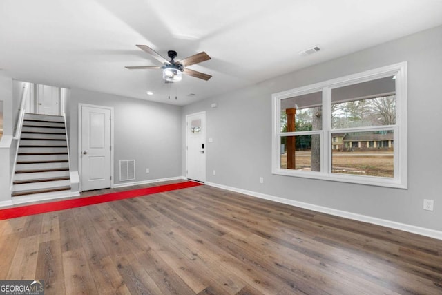 interior space with ceiling fan and dark hardwood / wood-style flooring