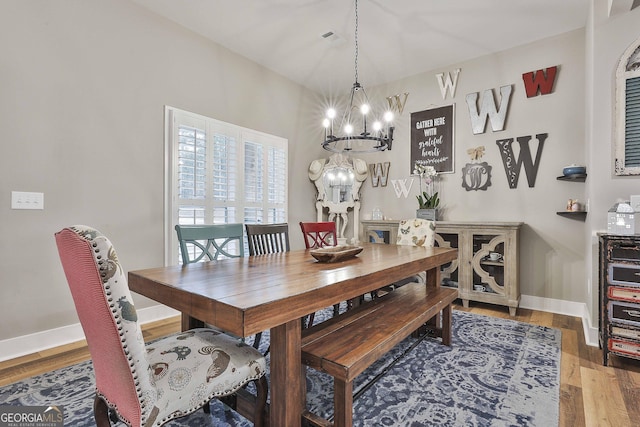 dining room with an inviting chandelier and hardwood / wood-style floors