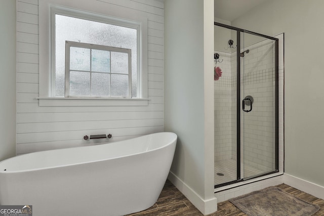 bathroom with separate shower and tub, hardwood / wood-style floors, and wooden walls