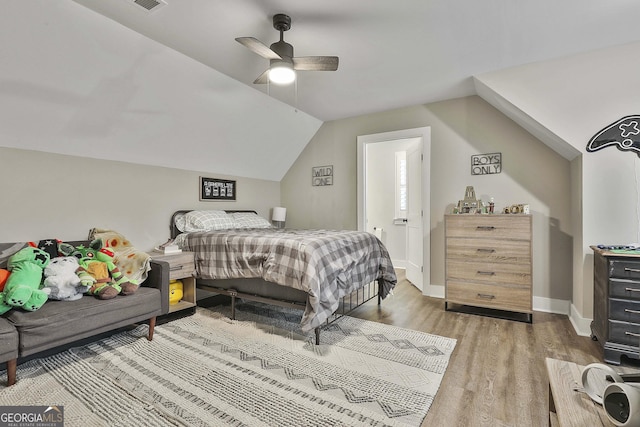 bedroom with ceiling fan, lofted ceiling, and wood-type flooring