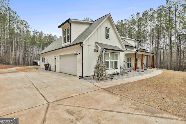 view of side of home with a garage and covered porch