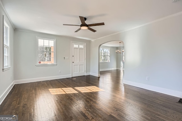 spare room featuring crown molding, dark hardwood / wood-style floors, and ceiling fan with notable chandelier