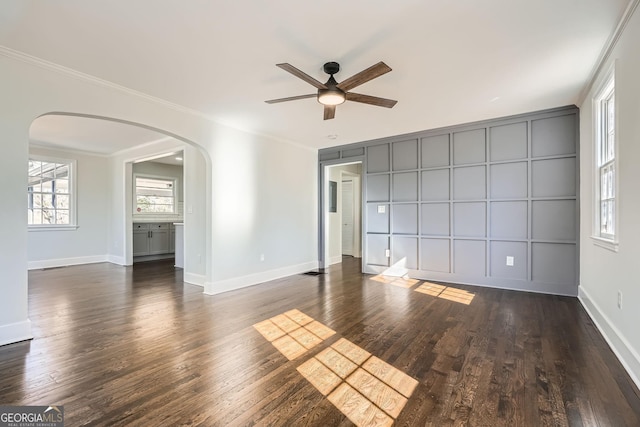 unfurnished room featuring dark hardwood / wood-style flooring, crown molding, and ceiling fan