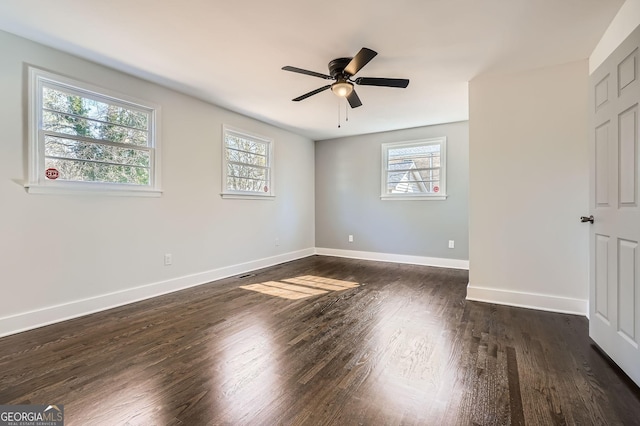 unfurnished room featuring ceiling fan, a healthy amount of sunlight, and dark hardwood / wood-style floors