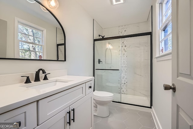 bathroom with vanity, toilet, tile patterned floors, and walk in shower