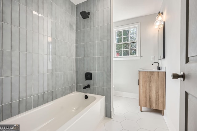 bathroom featuring vanity, tile patterned flooring, and tiled shower / bath