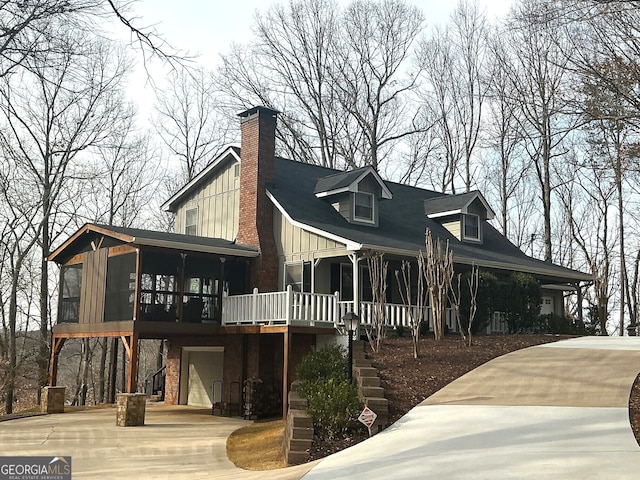 exterior space with a garage and a sunroom