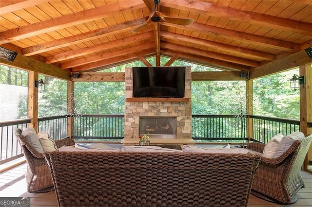 exterior space with a healthy amount of sunlight, vaulted ceiling with beams, wood ceiling, and an outdoor stone fireplace