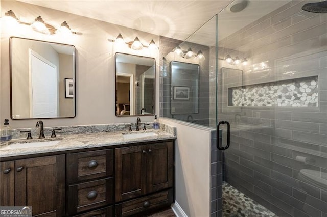 bathroom featuring vanity and a shower with door