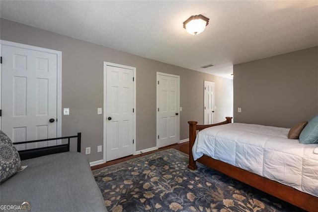 bedroom with dark hardwood / wood-style flooring