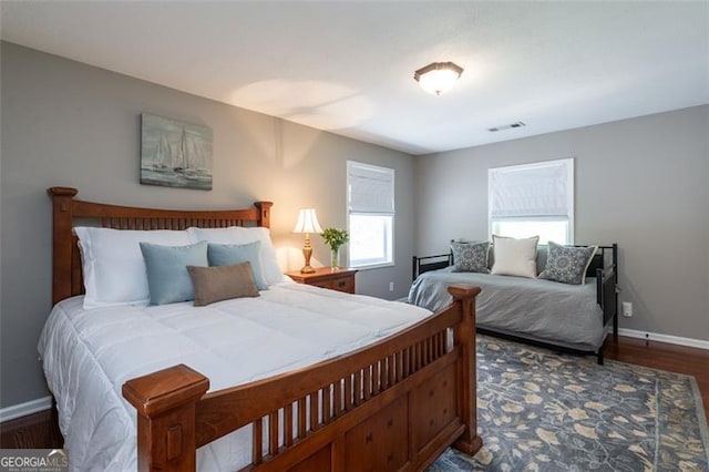 bedroom with dark wood-type flooring