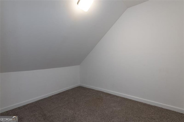 bonus room featuring carpet flooring and vaulted ceiling