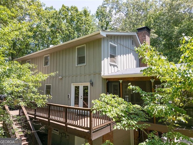 back of property with a wooden deck and french doors