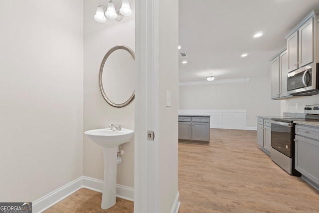 407 Crescent Ct, Griffin, GA 30224 - bathroom with wood finished floors, recessed lighting, a chandelier, and ornamental molding