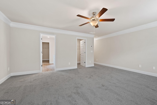 empty room featuring ceiling fan, ornamental molding, and carpet flooring