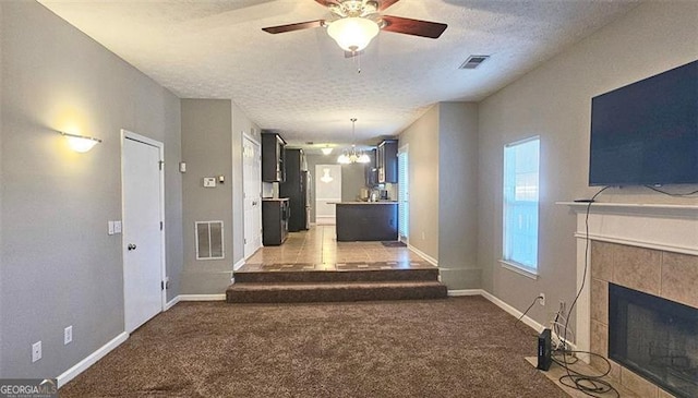 hall featuring light colored carpet, a notable chandelier, and a textured ceiling