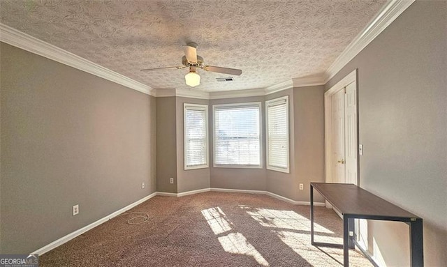 carpeted empty room with ornamental molding, ceiling fan, and a textured ceiling