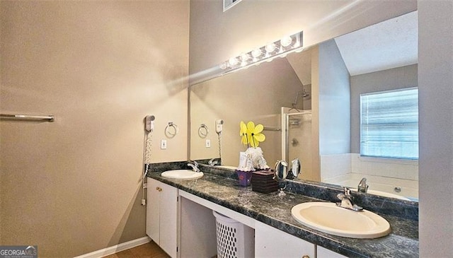 bathroom featuring vanity and independent shower and bath