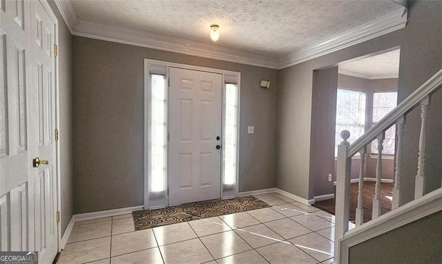 tiled foyer entrance with crown molding and a textured ceiling