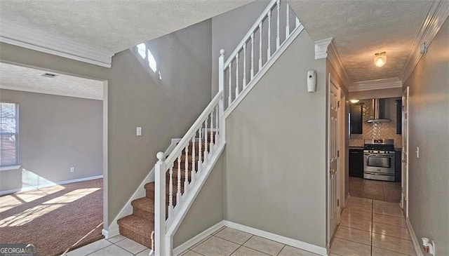 staircase featuring tile patterned flooring, crown molding, and a textured ceiling