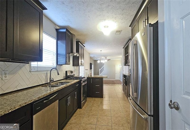 kitchen with sink, light tile patterned floors, dark stone countertops, stainless steel appliances, and decorative backsplash